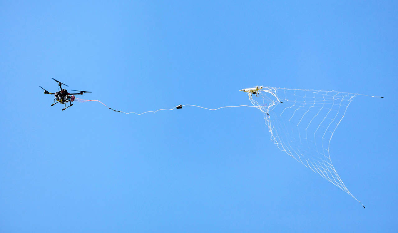 Overhead canopy moved by drones