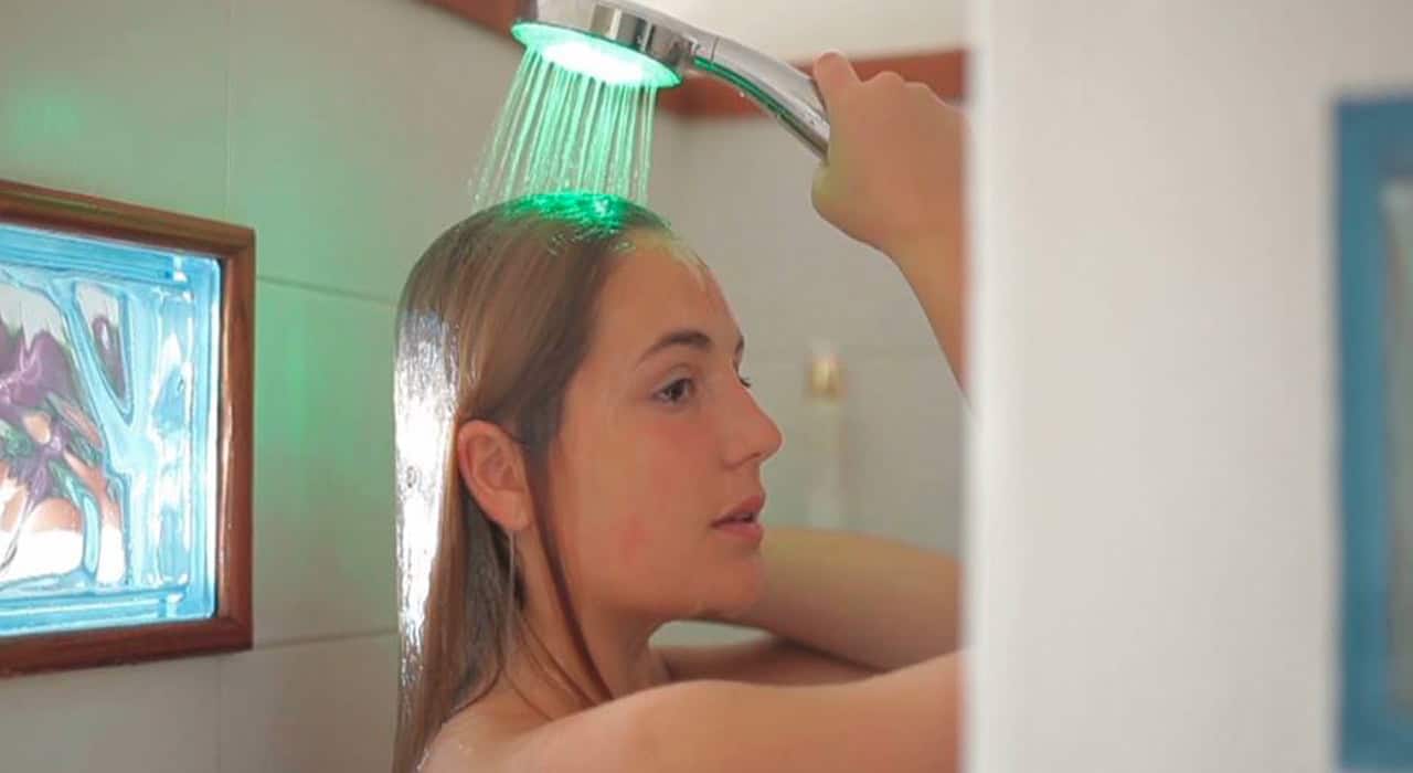 Smart shower head monitors water usage with lights and games